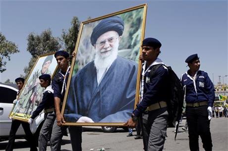 Iraqi Hezbollah march in Baghdad with a portrait of Iran's Supreme Leader