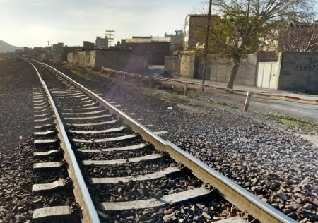 The single set of tracks of the Trans Iranian railroad, going through Arak, Iran. Arak is on the north side of the mountains and halfway between Tehran and Susa.