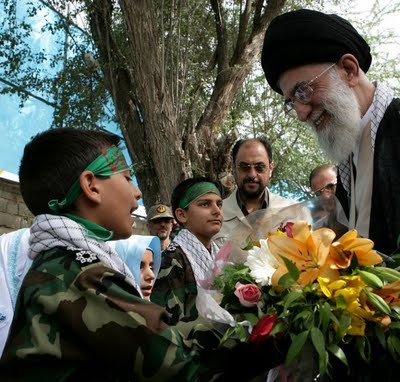 The top king of the Medes and Persians has a moment with one of his child fighters. Knowing this, the smile on Khamenei's face is creepy.